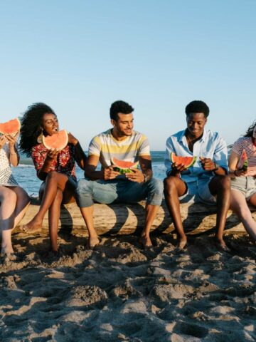 Friends eating snacks at the beach